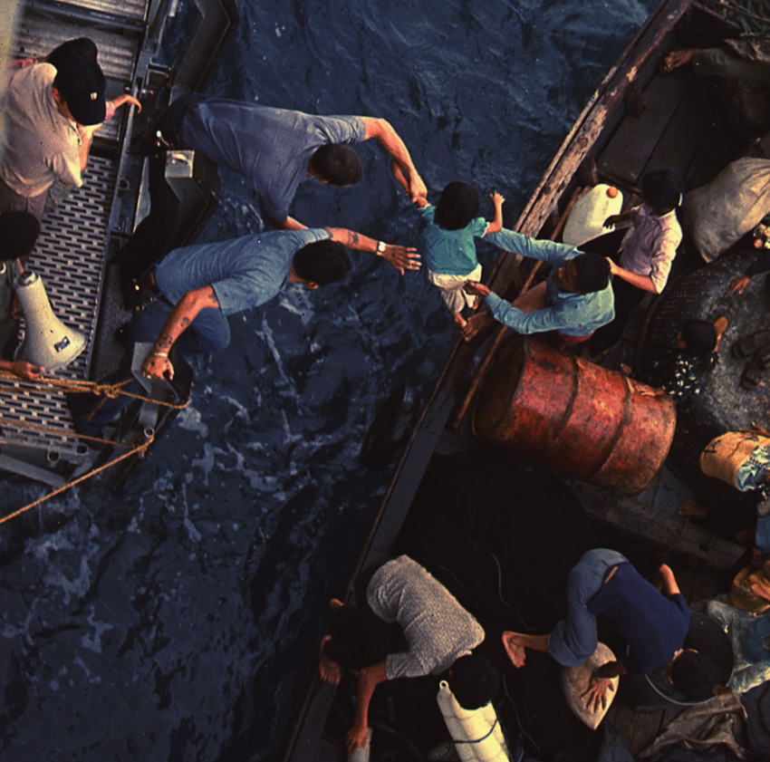 Crewmen of the USS Durham take Vietnamese refugees aboard in the South China Sea