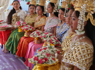 Young women are seated on stage during a celebration to mark the Khmer New Year in Lithonia, Georgia, 2010