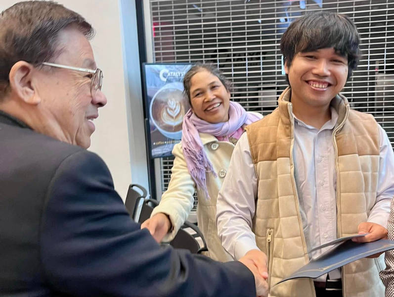 John Chen congratulates Montagnard graduate